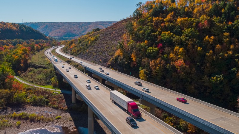 Scenic aerial view of the high bridge at the Pennsylvania Turnpike lying between mountains in Appalachian on a sunny day in fall